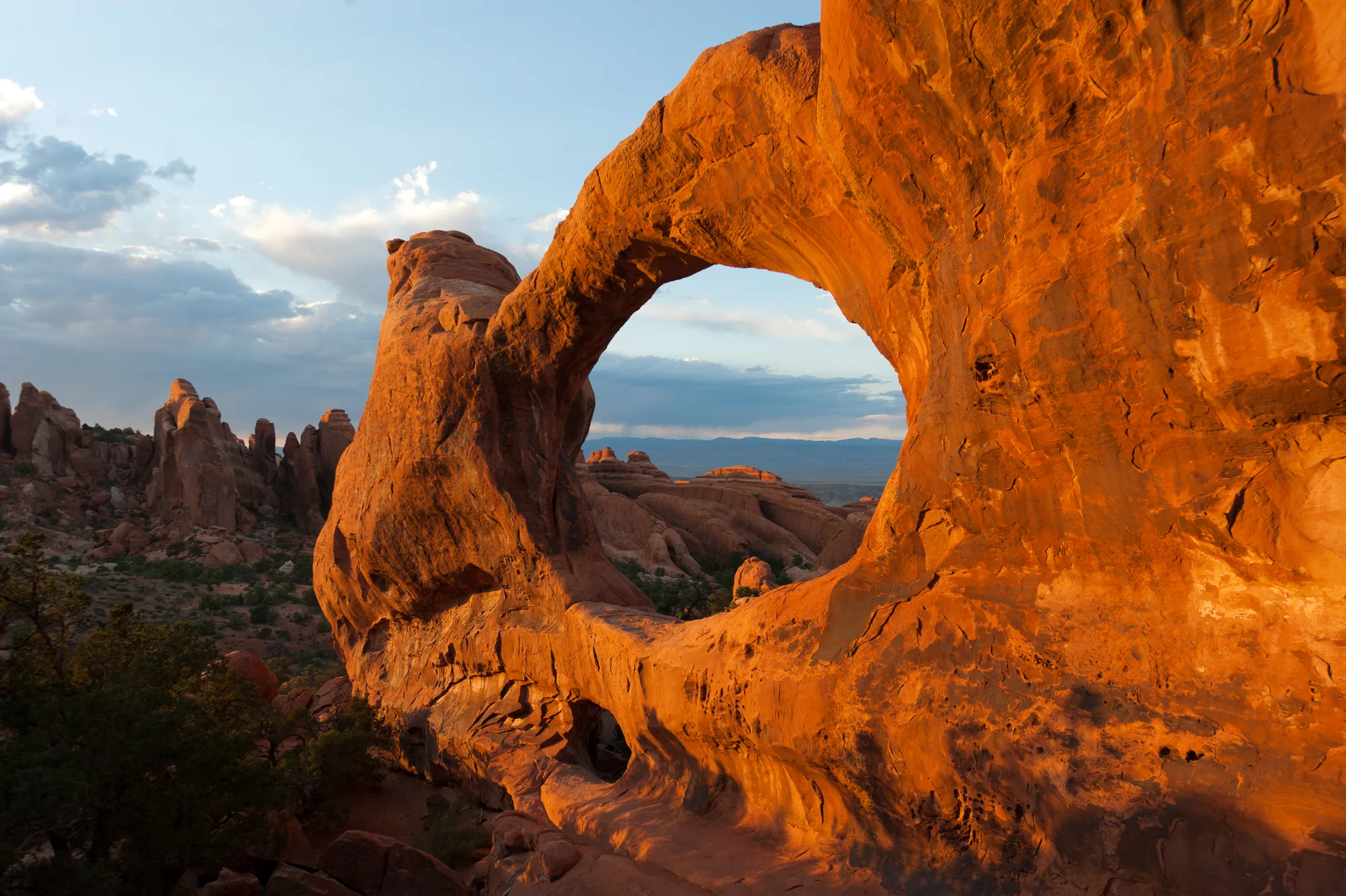A sandstone arch formation against a desert sky in Arches National Park